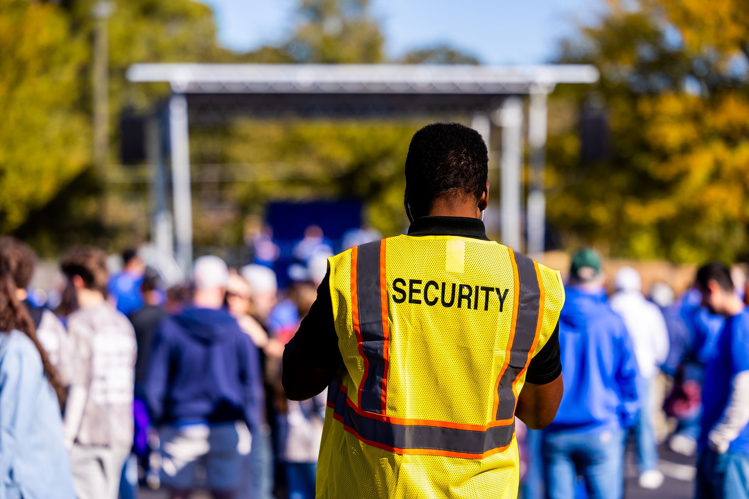 Event security professional monitoring an outdoor crowd